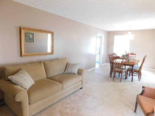 living room with light carpet and a notable chandelier