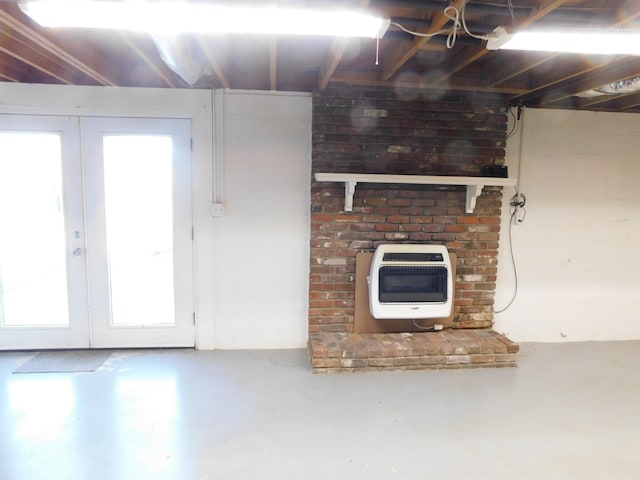 unfurnished living room with heating unit, concrete flooring, and french doors