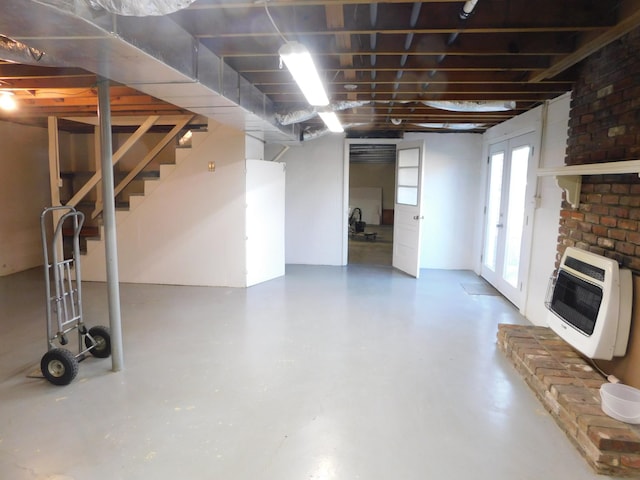 basement featuring heating unit and a fireplace