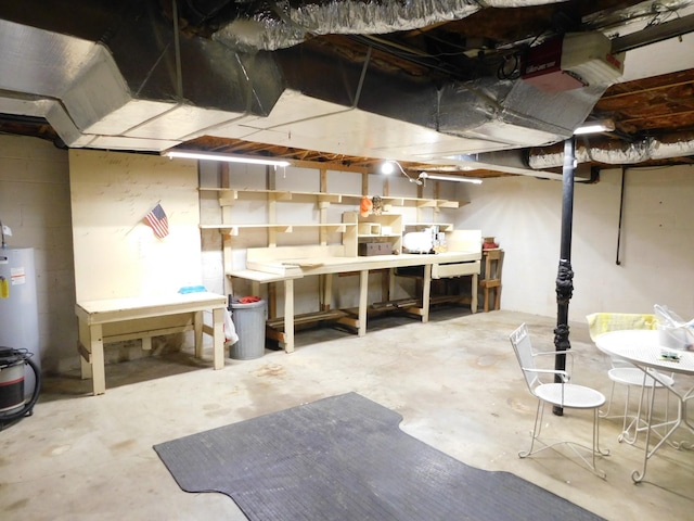 basement with water heater and a workshop area