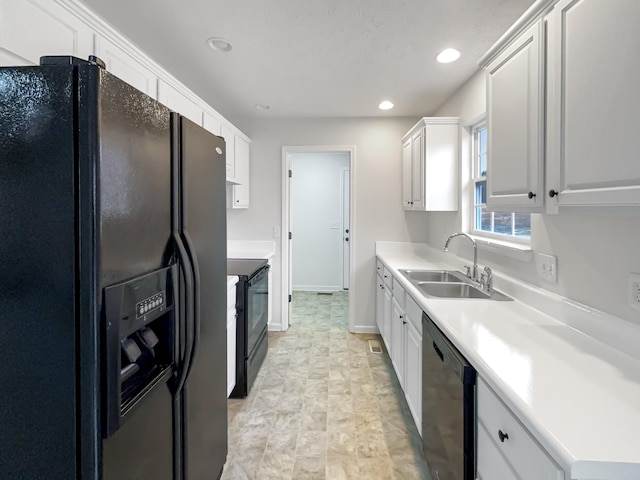 kitchen featuring white cabinetry, sink, and black appliances