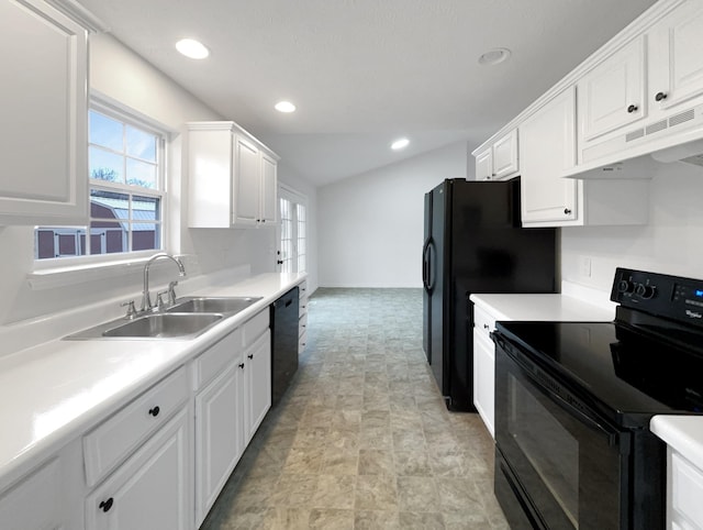 kitchen featuring sink, black appliances, and white cabinets