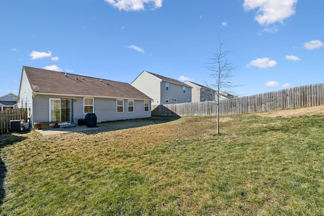 back of property featuring a lawn and a patio area