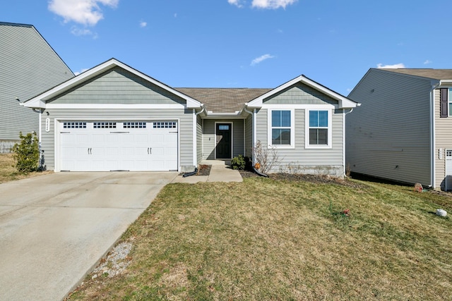 view of front of property with a garage and a front lawn