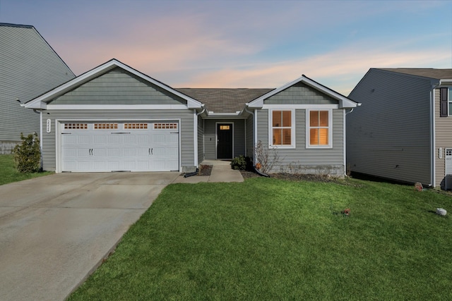 view of front of house featuring a garage and a yard