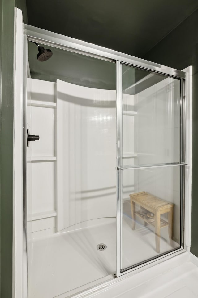 bathroom featuring a shower with shower door