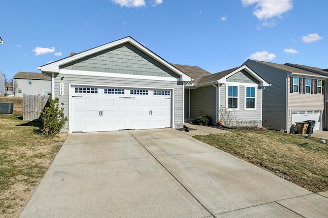 ranch-style house featuring a garage and a front lawn