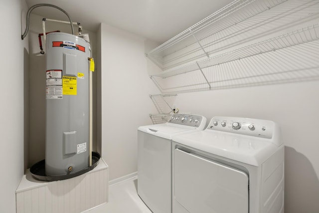 clothes washing area featuring washer and dryer and electric water heater