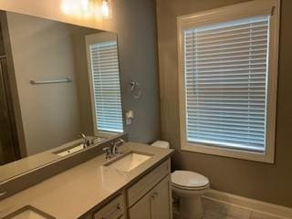 bathroom with tile patterned floors, vanity, and toilet