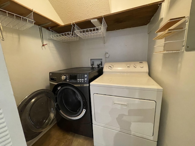 laundry area with hardwood / wood-style flooring and washing machine and clothes dryer