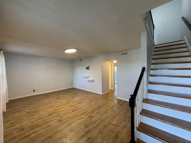 interior space featuring hardwood / wood-style floors and a textured ceiling