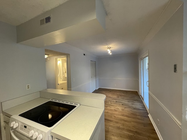 kitchen featuring hardwood / wood-style flooring, white electric range oven, a textured ceiling, and crown molding