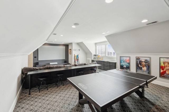 game room featuring dark carpet and vaulted ceiling