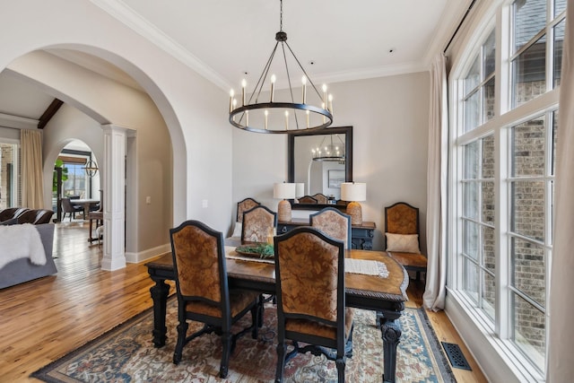 dining area featuring ornamental molding and hardwood / wood-style floors