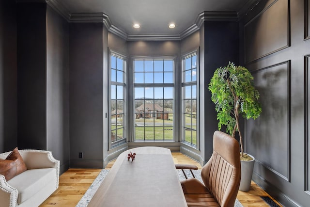 office area featuring crown molding, plenty of natural light, and light wood-type flooring