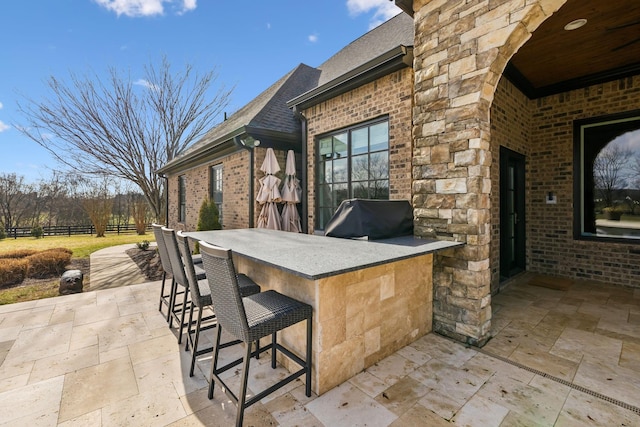 view of patio / terrace with a grill and an outdoor bar