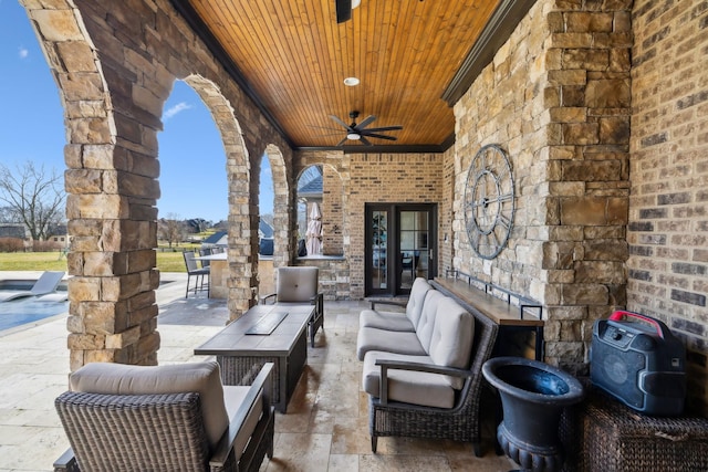 view of patio / terrace with ceiling fan and an outdoor living space