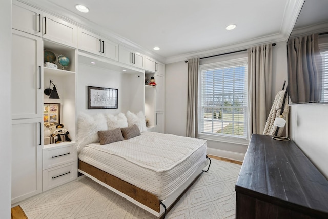 bedroom with ornamental molding and light hardwood / wood-style floors