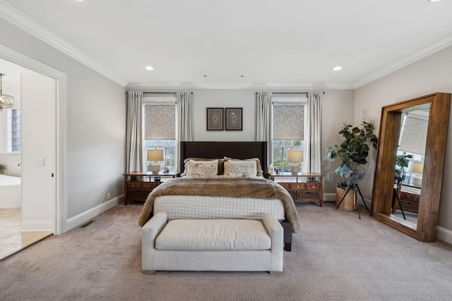 carpeted bedroom featuring crown molding and ensuite bath