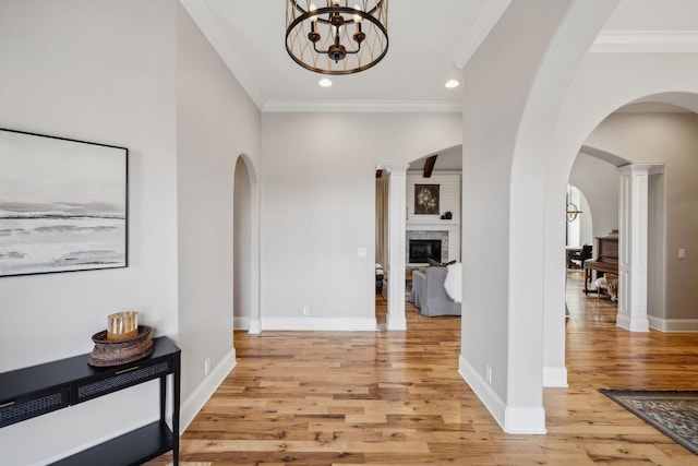 corridor featuring ornamental molding and light wood-type flooring