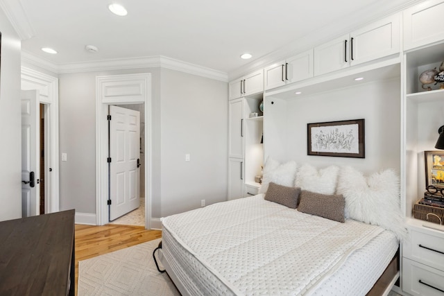 bedroom with light hardwood / wood-style flooring and ornamental molding