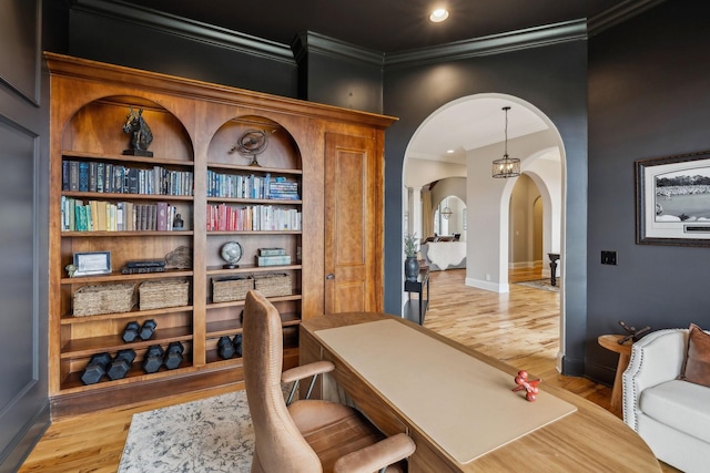 office space featuring crown molding and light hardwood / wood-style flooring