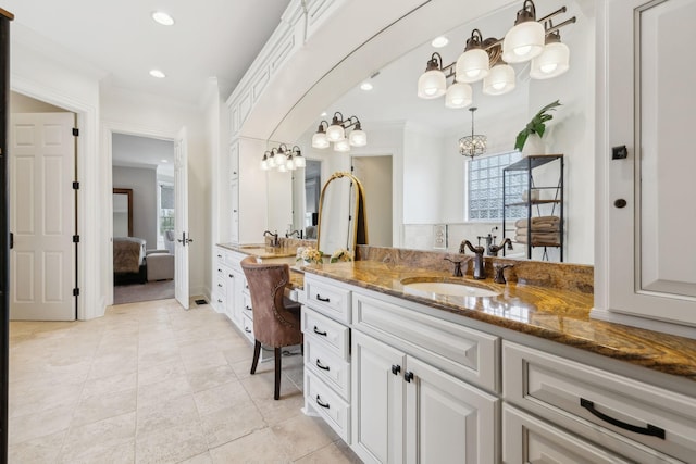 bathroom featuring tile patterned flooring, ornamental molding, and vanity