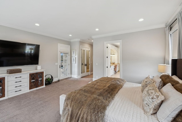 carpeted bedroom featuring ensuite bath and ornamental molding