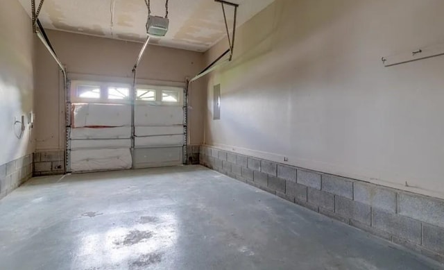 garage featuring a garage door opener and electric panel