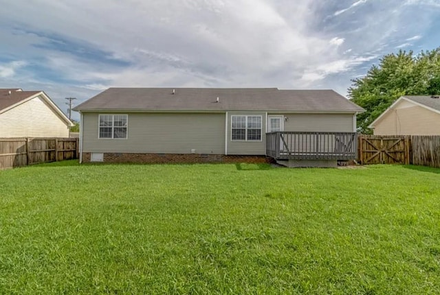 back of house with a wooden deck and a lawn