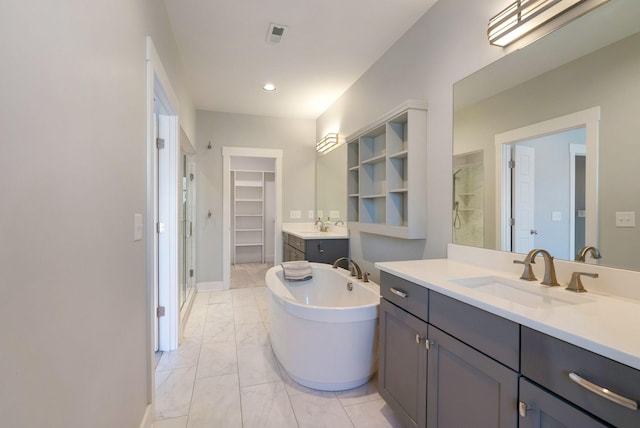 bathroom featuring vanity and shower with separate bathtub