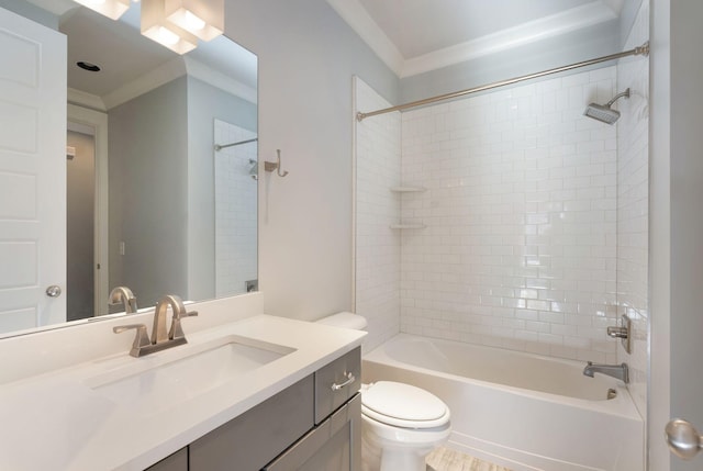 full bathroom featuring vanity, tiled shower / bath, crown molding, and toilet