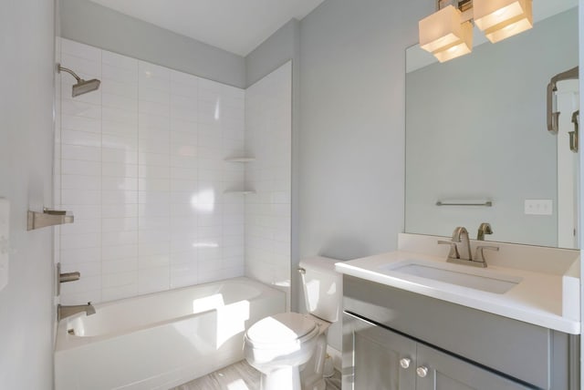 full bathroom featuring vanity, toilet, and tiled shower / bath combo