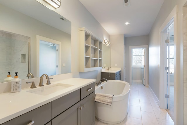 bathroom featuring vanity, a bathtub, and tile patterned floors