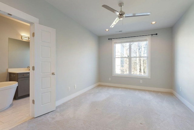 empty room with ceiling fan and light colored carpet