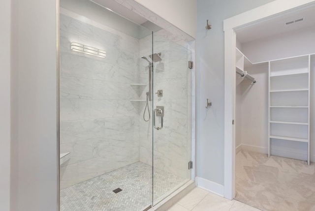 bathroom featuring a shower with door