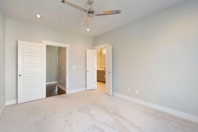 unfurnished bedroom featuring ensuite bathroom, carpet floors, and ceiling fan