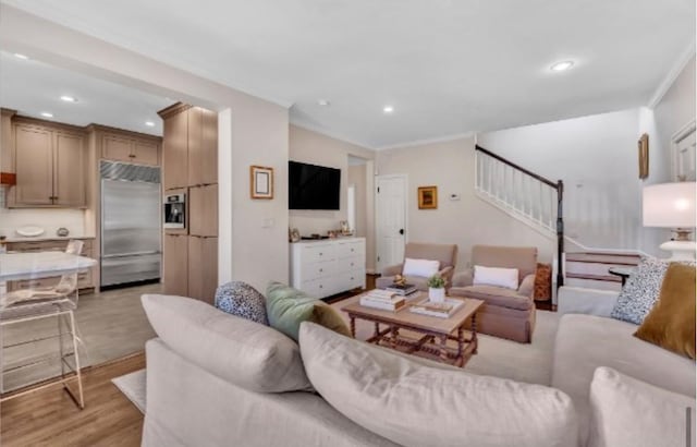 living room with ornamental molding and light wood-type flooring