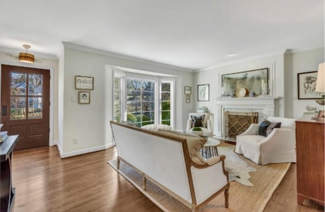 living room with hardwood / wood-style flooring and ornamental molding