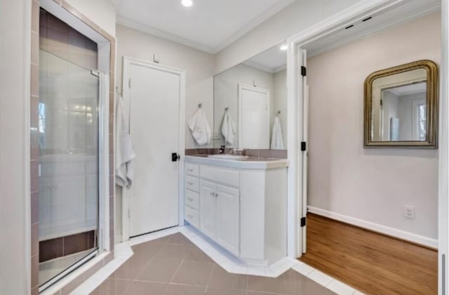 bathroom featuring an enclosed shower, ornamental molding, hardwood / wood-style floors, and vanity