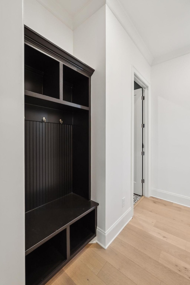 mudroom with hardwood / wood-style flooring and crown molding