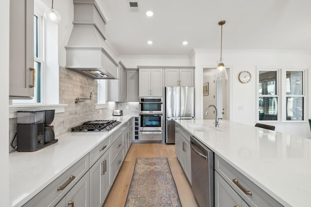 kitchen with stainless steel appliances, sink, pendant lighting, and gray cabinetry