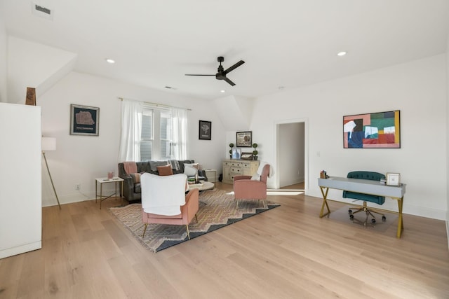 living room featuring ceiling fan and light hardwood / wood-style floors