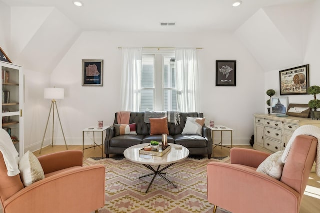 living room with lofted ceiling and light wood-type flooring