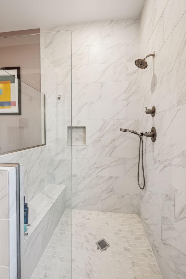 bathroom with tiled shower