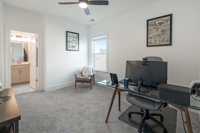 carpeted office featuring ceiling fan and sink