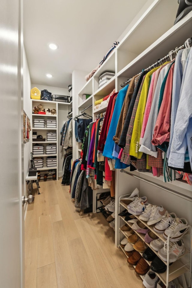 walk in closet with light wood-type flooring