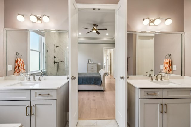 bathroom with vanity, ornamental molding, a shower with door, and ceiling fan