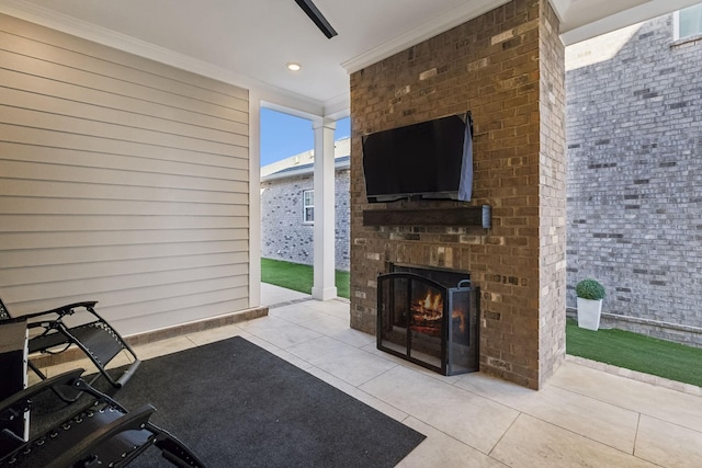 view of patio featuring an outdoor brick fireplace and ceiling fan