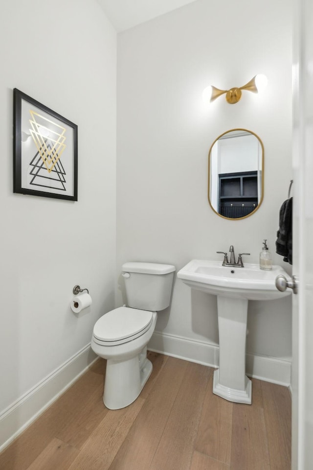 bathroom with wood-type flooring and toilet